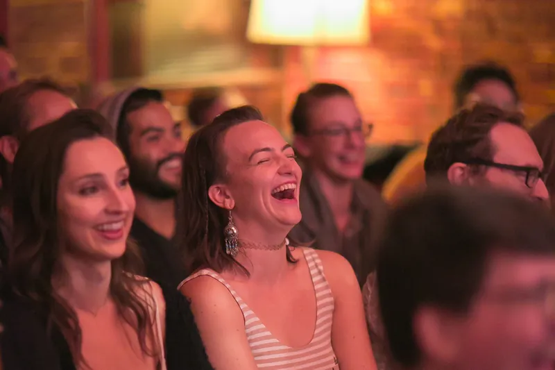 A woman in the front rows laughing at a Jetpack show