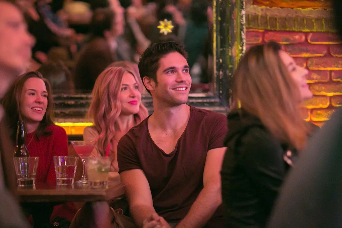 Friends enjoying cocktails at Jetpack Comedy — drinks on table at Bar Lubitsch