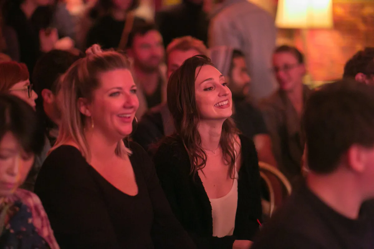 Two friends laughing at Jetpack Comedy